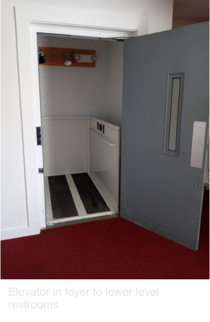 Elevator in foyer to lower level restrooms