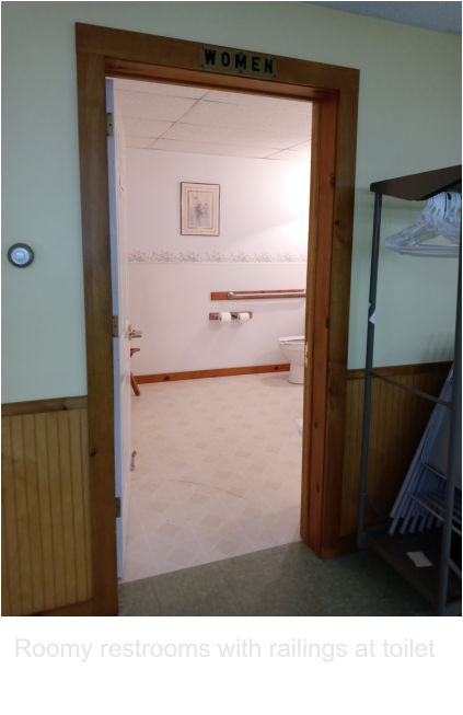 Roomy restrooms with railings at toilet